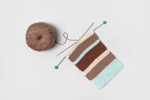 Ball of thread with knitting needles and fabric Stock Photos