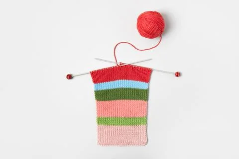 Ball of thread with knitting needles and knitted fabric Stock Photos