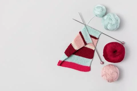 Ball of thread with knitting needles and fabric Stock Photos