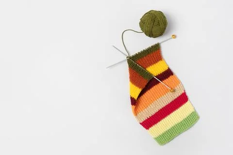 Ball of thread with knitting needles and knitted fabric Stock Photos