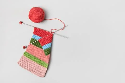 Ball of thread with knitting needles and knitted fabric Stock Photos