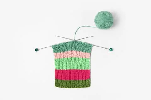 Ball of thread with knitting needles and knitted fabric Stock Photos