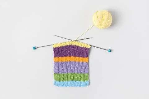 Ball of thread with knitting needles and knitted fabric Stock Photos