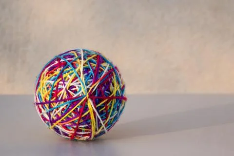 A ball of woolen threads of different colors. Stock Photos
