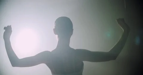 Ballerina dances on stage, close-up with magic light and smoke on the background Stock Footage 73936630