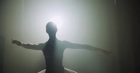 Ballerina dances on stage, close-up with magic light and smoke on the background Stock-Footage 73936820