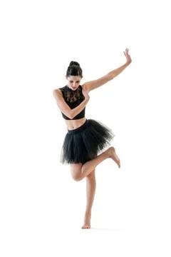 Ballerina dancing and posing in studio for a performance wearing black Stock Photos