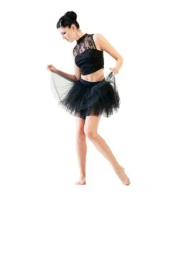 Ballerina dancing and posing in studio for a performance wearing black Stock Photos