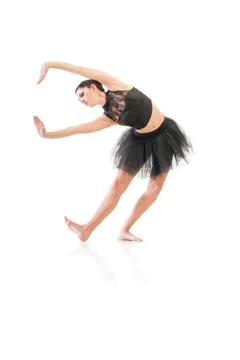 Ballerina dancing and posing in studio for a performance wearing black Stock Photos