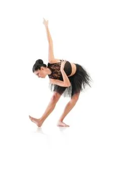 Ballerina dancing and posing in studio for a performance wearing black Stock Photos