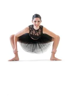 Ballerina dancing and posing in studio for a performance wearing black Foto stock