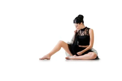 Ballerina dancing and posing in studio for a performance wearing black Foto stock
