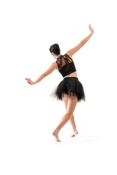 Ballerina dancing and posing in studio for a performance wearing black Stock Photos