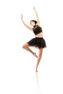 Ballerina dancing and posing in studio for a performance wearing black Foto stock