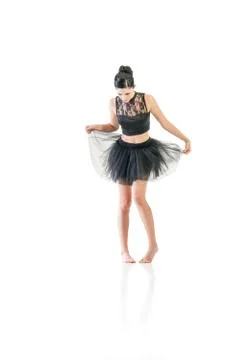 Ballerina dancing and posing in studio for a performance wearing black Stock Photos