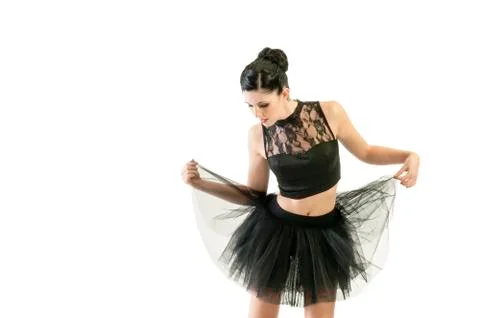 Ballerina dancing and posing in studio for a performance wearing black Stock Photos