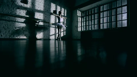 Ballerina dancing in a dark studio Stock Footage 56766233