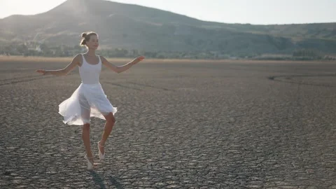Ballerina dancing on a dried lake Stock Footage 280361815