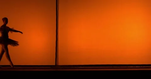 Ballerina dancing in front of an orange background Video stock 55567097