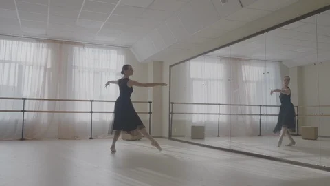 Ballerina dancing in studio in front of mirror Stock Footage 92985045