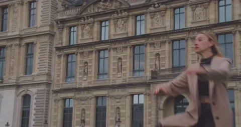 Ballerina does jump with Paris architecture in background, fit woman model Stock Footage 233317221