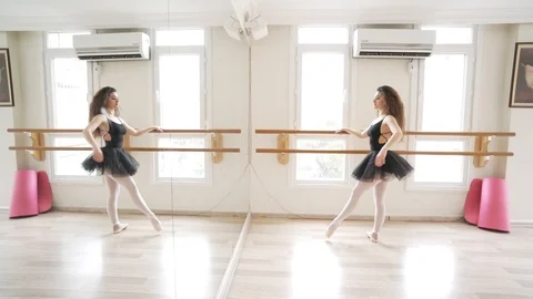 Ballerina doing practice and stretching movements in studio Video stock 104657819