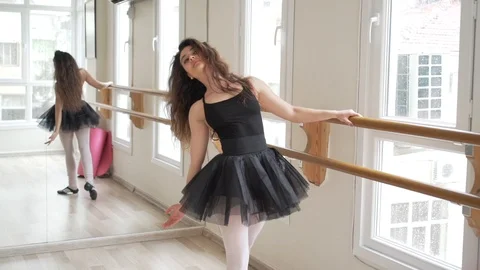 Ballerina doing practice and stretching movements in studio Stock Footage 104661468
