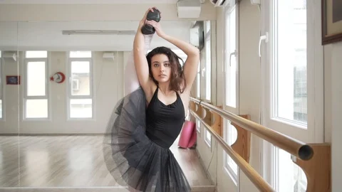 Ballerina doing practice and stretching movements in studio Stock Footage 104662560
