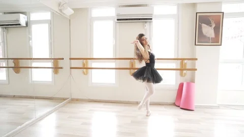 Ballerina doing practice and stretching movements in studio Stock Footage 104663058