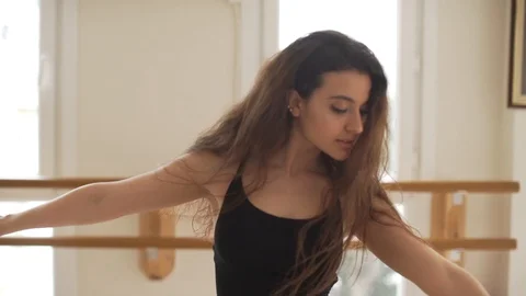 Ballerina doing practice and stretching movements in studio Stock Footage 104666964