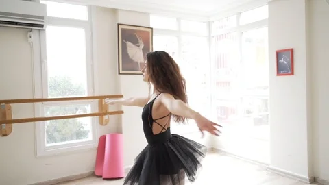 Ballerina doing practice and stretching movements in studio Stock Footage 104678084