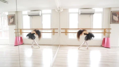 Ballerina doing practice and stretching movements in studio Stock Footage 104679617