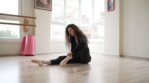 Ballerina doing practice and stretching movements in studio Stock Footage 104686870