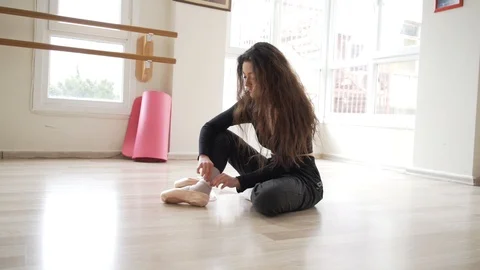 Ballerina doing practice and stretching movements in studio Video stock 104688060