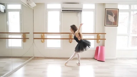 Ballerina doing practice and stretching movements in studio Stock Footage 104690317