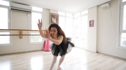 Ballerina doing practice and stretching movements in studio Stock Footage 104690739
