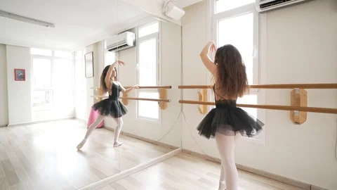 Ballerina doing practice and stretching movements in studio Video stock 104691435