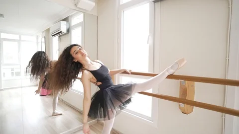 Ballerina doing practice and stretching movements in studio Stock Footage 104691580