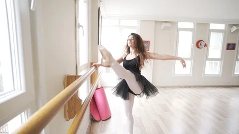 Ballerina doing practice and stretching movements in studio Video stock 104692733