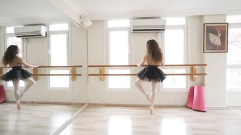Ballerina doing practice and stretching movements in studio Stock Footage 104692968
