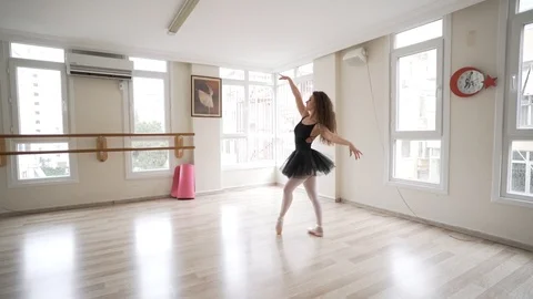 Ballerina doing practice and stretching movements in studio Stock Footage 104693951