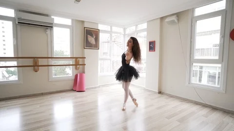 Ballerina doing practice and stretching movements in studio Stock Footage 104693963