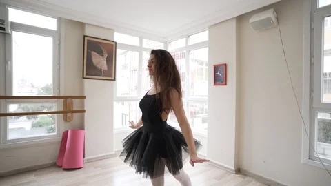 Ballerina doing practice and stretching movements in studio Stock Footage