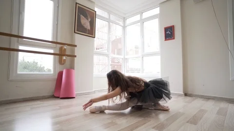 Ballerina doing practice and stretching movements in studio Stock Footage 104694678