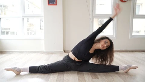 Ballerina doing practice and stretching movements in studio Video stock 104696672