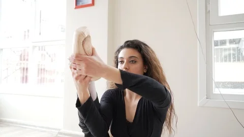 Ballerina doing practice and stretching movements in studio Stock Footage 104697750