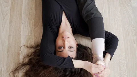 Ballerina doing practice and stretching movements in studio Video stock 104698514