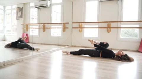 Ballerina doing practice and stretching movements in studio Stock Footage 104699568