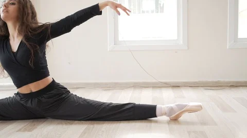 Ballerina doing practice and stretching movements in studio Stock Footage 104699950