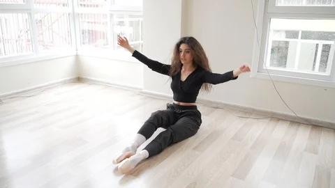 Ballerina doing practice and stretching movements in studio Video stock 104700245